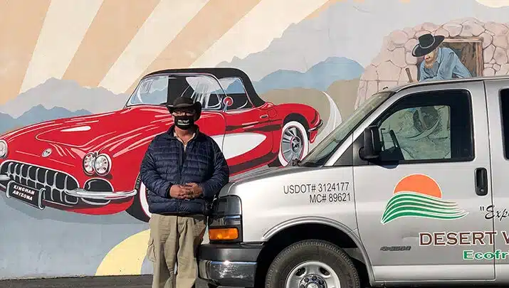 Bob Walton of Desert Wonder Tours poses for a photo with his tour van by the Mohave Museum of History and Arts at 400 W. Beale St. in Kingman. (Photo by Agata Popeda/Kingman Miner)